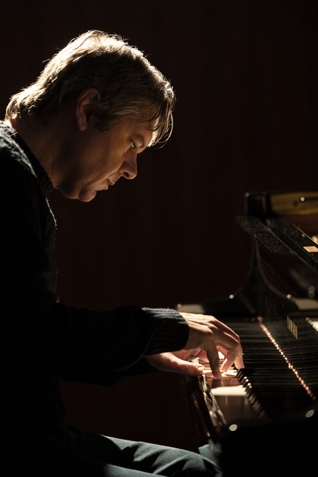 Lorenzo Masotto playing an acoustic grand piano